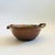 A vintage hand made studio pottery bowl. Features a twisted handle and a spout formed into the rim. Purple glaze with a...