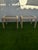 A beautiful pair of vintage rattan waterfall side tables with glass top inserts. These timeless tables have a clean...