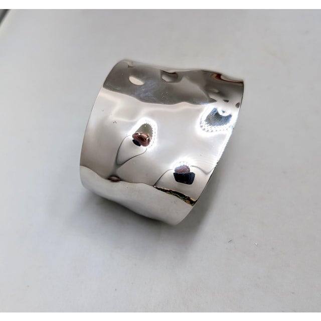 1977 rhodium plated wavy/bumpy slide on cuff bracelet. Marked "NAPIER©" in the center inside of the cuff near the edge....