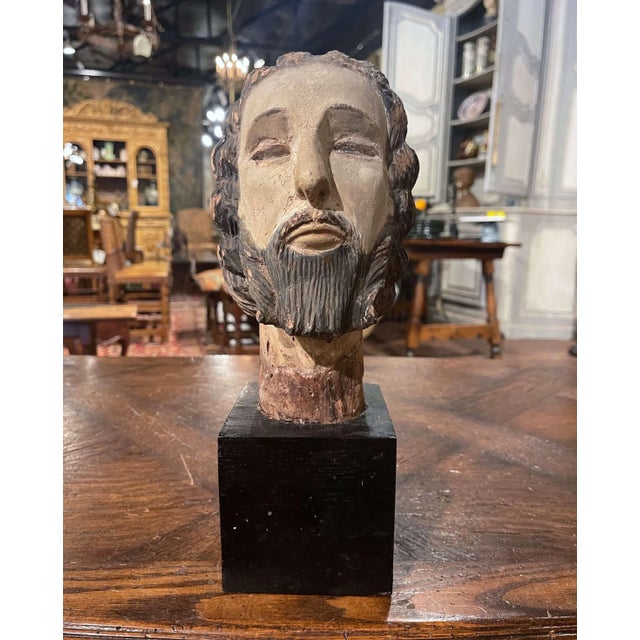 Crafted in Spain, circa 1680, this antique carved wooden bust depicts the head of Christ with a strikingly expressive,...
