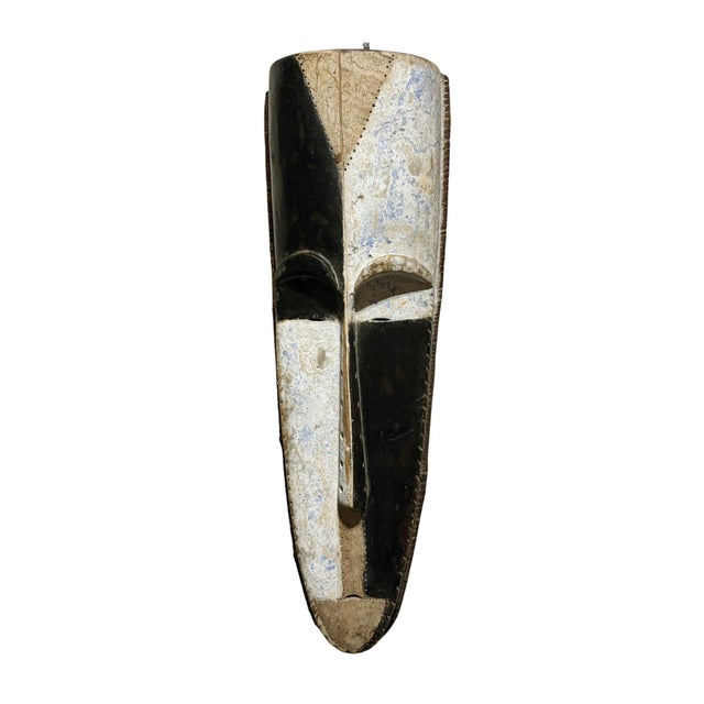 Superb vintage Fang mask carved from a single piece of heavy wood, featuring an elongated heart-shaped face rendered in...