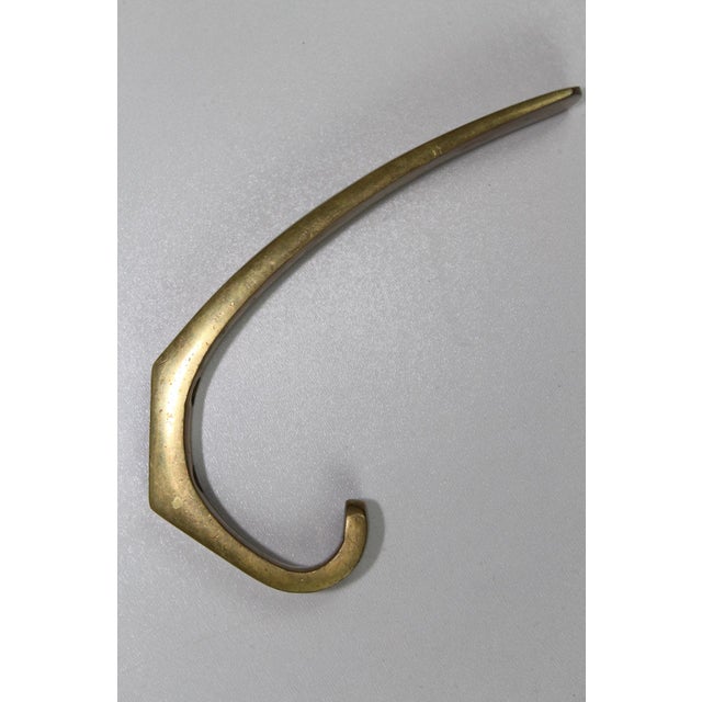 This set of 6 heavy, solid brass hooks, with original age patina, can be easily polished to a high gloss.