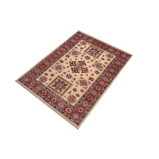 Enhance your home with this exquisite hand-knotted Kazak rug, crafted from fine hand-spun wool and dyed with all-natural...