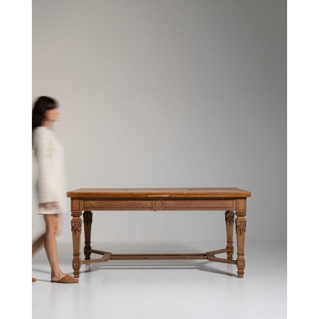 Extending walnut trestle table in Rich Walnut Brown. The rich walnut brown surface highlights pull-apart extension leaves,...