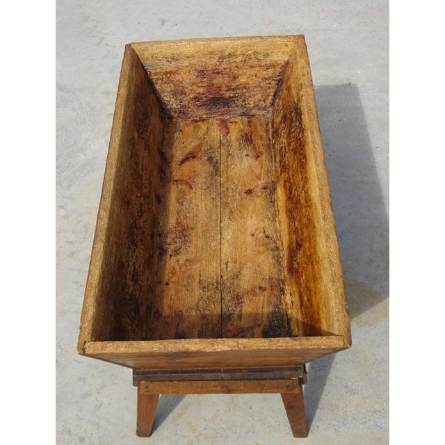 A 19th-century kneading trough on a removable stand with a lid, made entirely of solid oak. The rustic, pegged base...