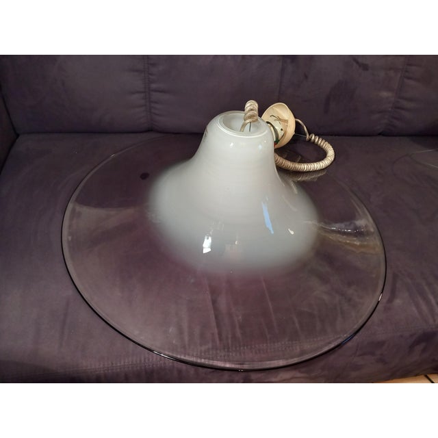 The pendant light is equipped with one E27 socket; it is shipped without a bulb. The glass lampshade is in excellent...