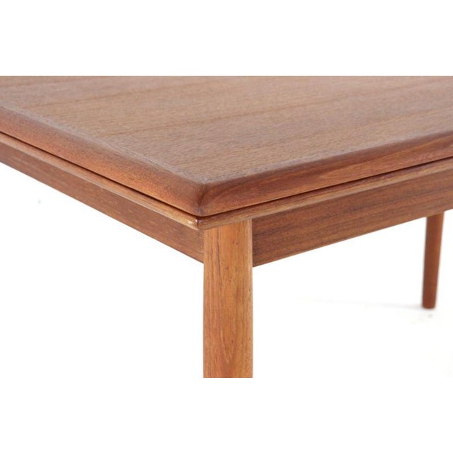 Extendable teak dining table. The table can be extended using a clever mechanism. Under the tabletop, on both sides, there...