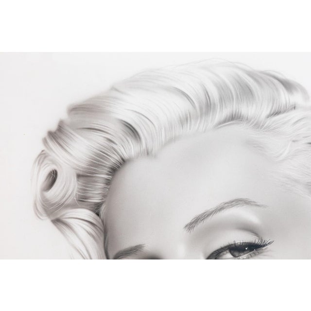 An alluring tribute to Hollywood’s most iconic muse, this mixed-media portrait captures Marilyn Monroe in striking...