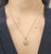 This elegant pendant necklace features a natural pear-cut white diamond, weighing 1.51 carats, with a clarity of SI2 and a...