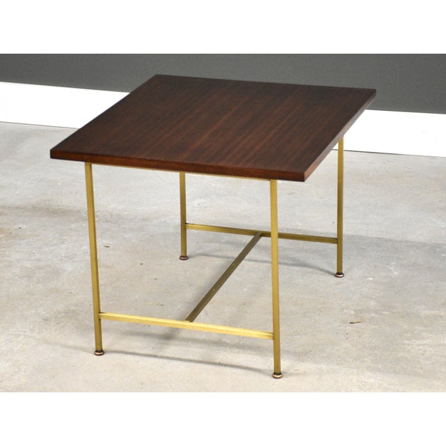 A mid century modern brass and mahogany rectangular end table designed by Paul McCobb for Calvin. Professionally...