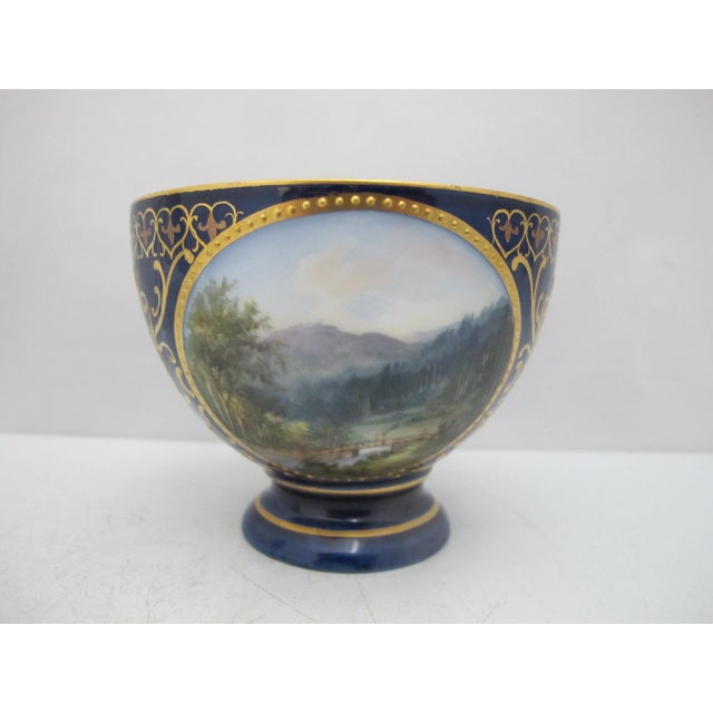 19th century, Karlsbad Hermann Voigt, Bohemia porcelain footed cup and saucer. Cobalt blue with ornate gilt accents and...