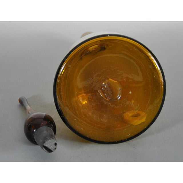 A piece from the collection of a long retired interior decorator. Vintage Blenko decanter standing approximately 23" tall....