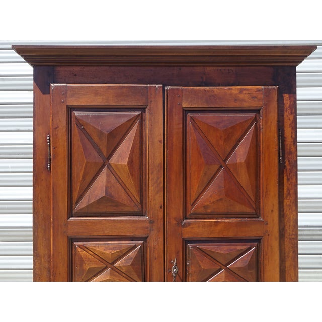 A very old, fully restored Louis XIII wardrobe of medium size. Made in the 19th century, assembled with wooden pegs. Doors...