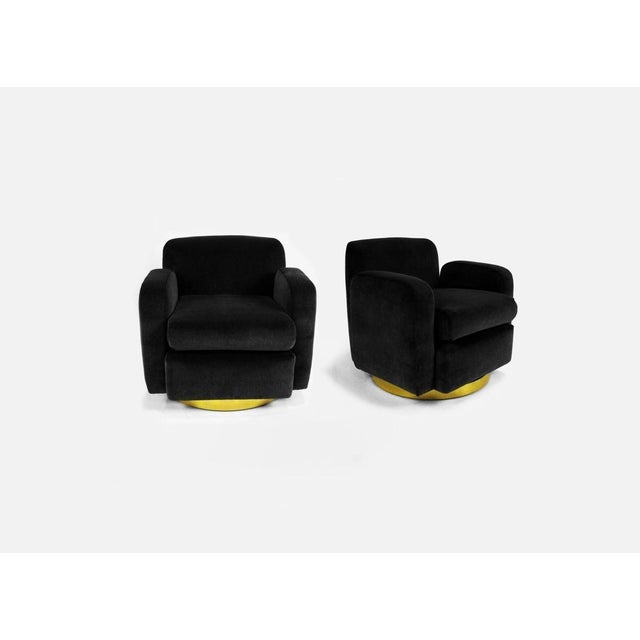 The club chair has been popular since the 1930's, presented is a pair of sculptural swivel armchairs by the iconic Milo...