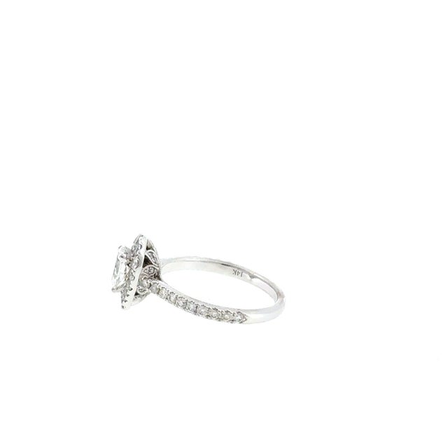 This exquisite engagement ring by renowned designer Neil Lane features a brilliant pear-cut center diamond weighing...