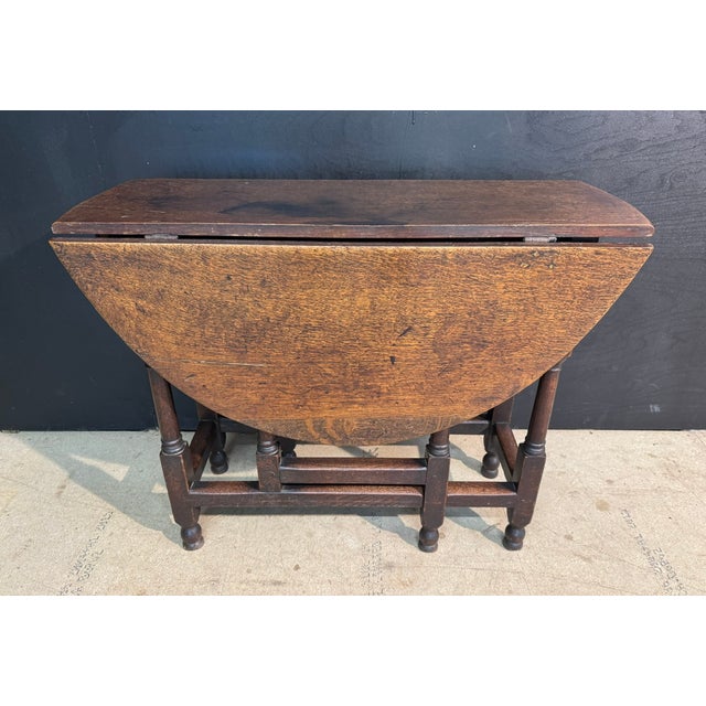 A Charming 18th Century English Oak Gate Leg Table. Having a drawer to one end. Lovely original deep colour and patina. In...