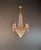 An elegant antique Italian crystal chandelier dating from around 1920. Its tall, slender silhouette blends classical...