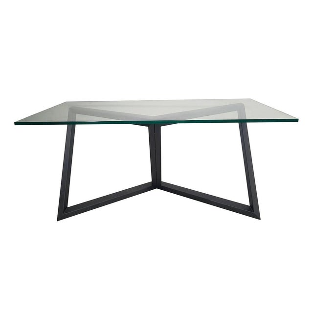 Iron base of the table inspired by the union of four of the six diagonals inside the cube. The top is made of crystal....