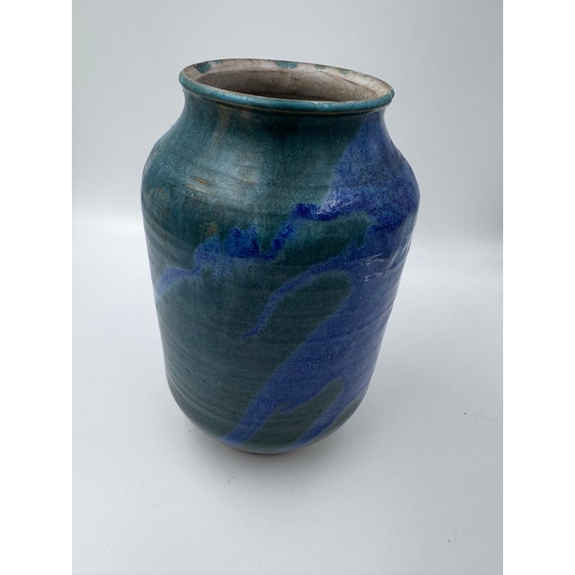 A striking vintage studio pottery vase featuring a beautifully layered glaze in saturated cobalt blue, teal and deep blue-...