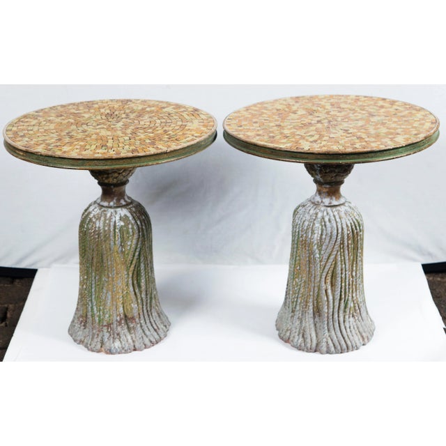 Pair of gold ceramic mosaic tile top tassel tables. Cast iron tassel shaped bases are cement filled for weight. Mosaic...