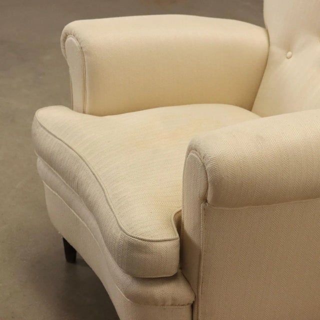 Armchair, spring padding, feather pillow, fabric covering. This piece is attributed to the mentioned designer/maker. It...