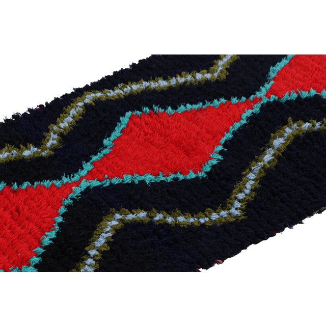 Hand-knotted in wool and originating from Morocco circa 1950-1960, this 2x6 vintage Moroccan rug is an extremely rare...