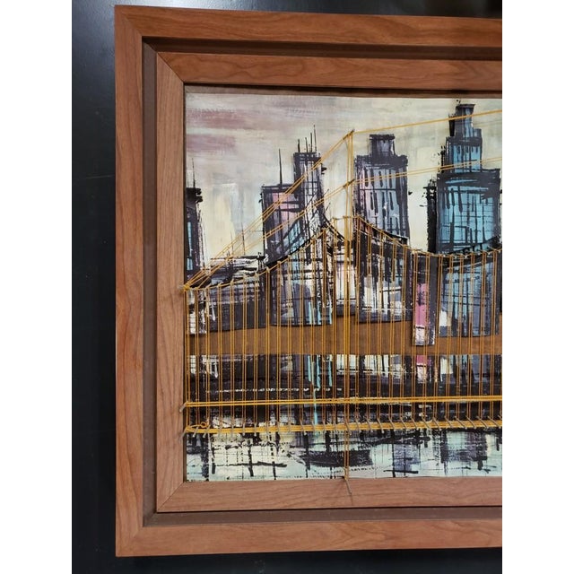 This is a 1960s Mid Century Modern Brooklyn Bridge, New York City Skyline Mixed Media Art, Framed. It measures 22 1/2"...