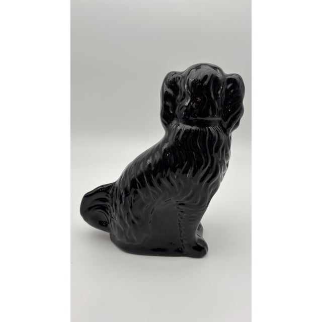 Beautiful matched pair of antique Staffordshire spaniel mantel dogs in a deep glossy black Jackfield-type glaze with hand-...