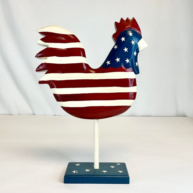 This is a delightful painted wooden Patriotic Americana Chicken. It’ features red and ivory stripes throughout its body...