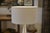 Designer table lamp in brushed aluminum, 1970s. Teardrop-shaped base with flowing lines and a satin finish that...