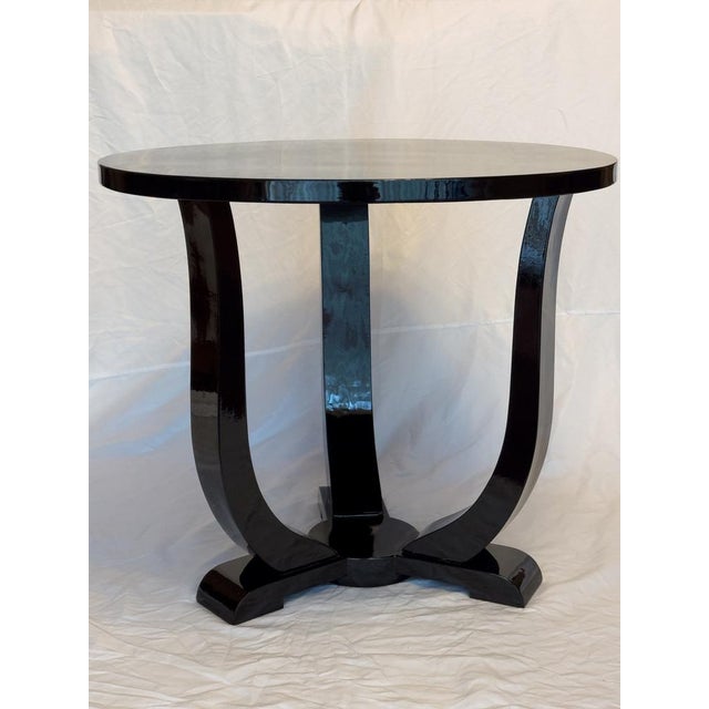 This Art Deco walnut Black Lacquer side table from 1930s France was crafted with a round structure, it features three...