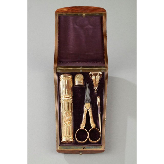 A 18th century set presented in trapezoidal case made of light wood and inlaid with marquetry. The vanity case includes a...