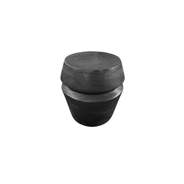 Crafted from solid mango wood, this sculptural side table showcases a bold silhouette enhanced by a deeply charred black...