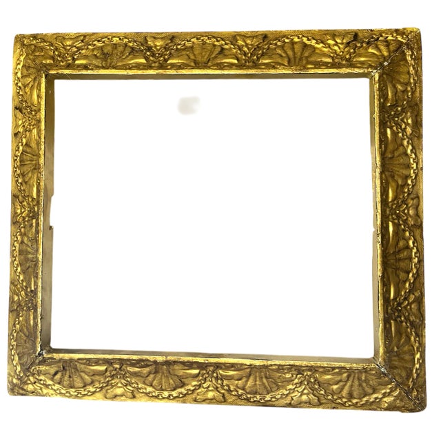 A beautifully aged antique giltwood frame featuring an elegant repeating shell and swag motif—a hallmark of late century...