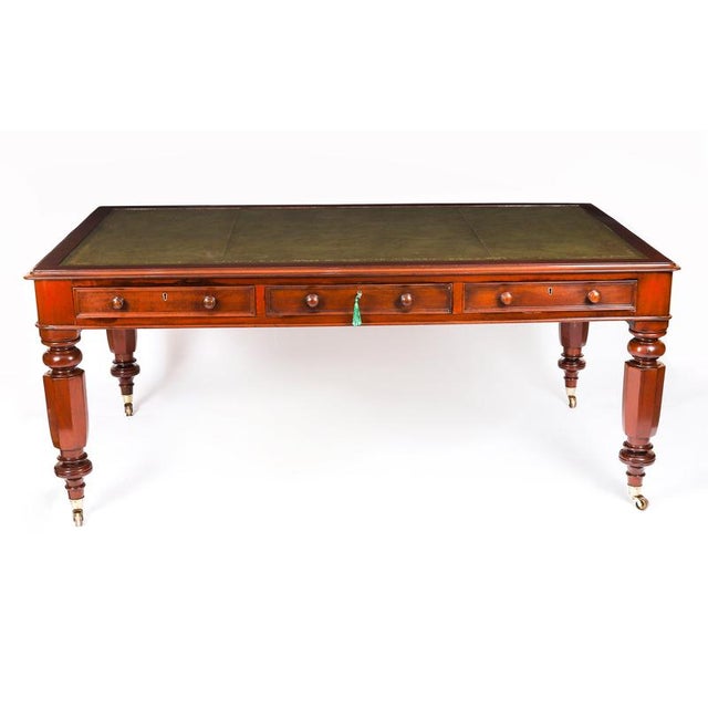 This elegant large Victorian antique partners library table was crafted from beautiful flame mahogany by W. Priest of...