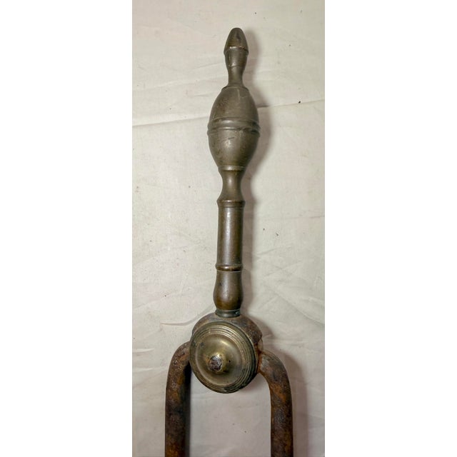 Up for sale is a nice pair of rare antique 18th century wrought iron and brass English fireplace tongs. The arms are...
