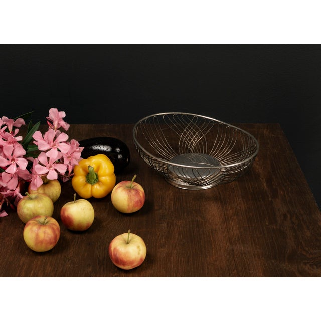 This lightweight, timeless fruit basket crafted from bent metal wire in the Mid Century Modern style combines functional...