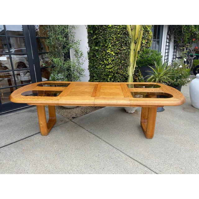 Vintage solid oak oval dining table. Solid oak legs/base with smokey glass enlay on top. Very heavy. and solid oak table,...