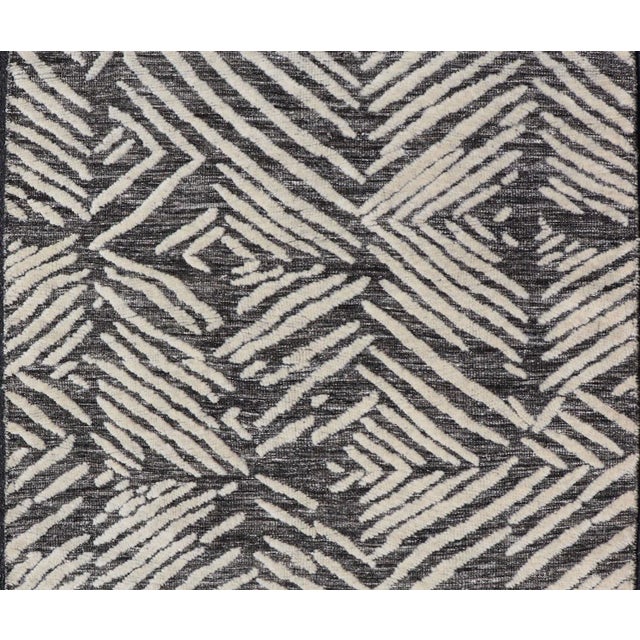 Measures 3'11 x 4'11 This exotic and contemporary piece is small but is very stylish. The abstract pattern loosely...