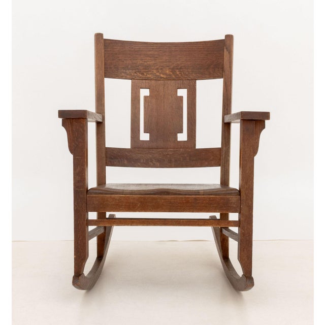Arts and Crafts Oak Rocking Chair, with geometric backsplat. 34.25" H x 27.5" W x 35.5" D; seat: 15" H. Provenance: From a...