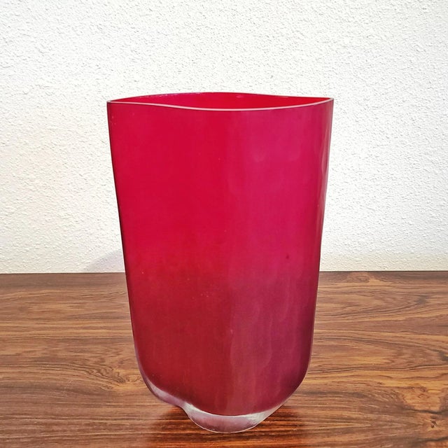 A beautiful, deep cranberry red, art glass vase, with a cyclone “footprint” and a particularly nice, overall battuto...