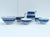 A lovely collection of English pottery, including five bowls and a pitcher, decorated with blue stripes on classic white...