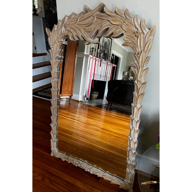 Vintage Serge Roche style carved frond mirror featuring an elegant, nature-inspired frame with intricate detailing. This...