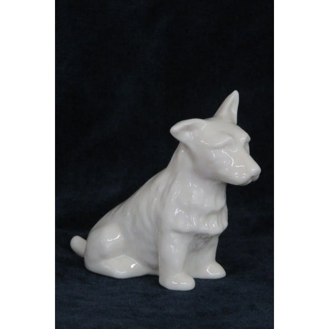 This adorable figurine is made of porcelain. This figurine is stamped on the bottom as having been made by Belleek in...