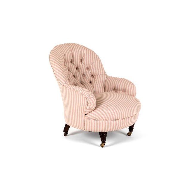 A generously proportioned over stuffed cornelius v. Smith button back armchair in pink stripe linen. Mahogany turned front...