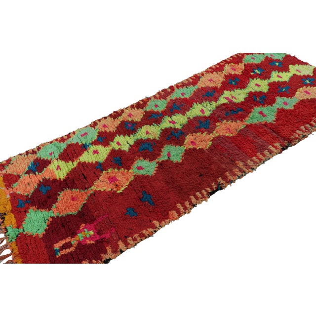 Hand-knotted in wool circa 1950-1960, this 4x9 vintage Moroccan rug with geometric patterns hails from the Azilal tribe....