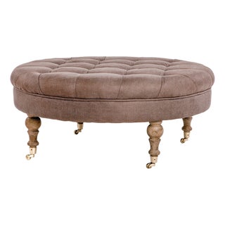 Maison Round Tufted Ottoman in Taupe Linen with Weathered Oak Turned Legs For Sale