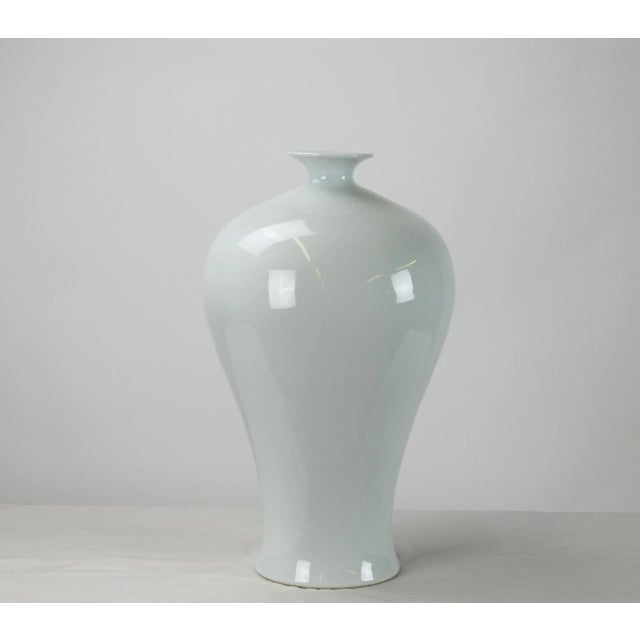 This contemporary vase with glossy white finish and smooth high shoulders pose a simple streamline form. Each one is hand...