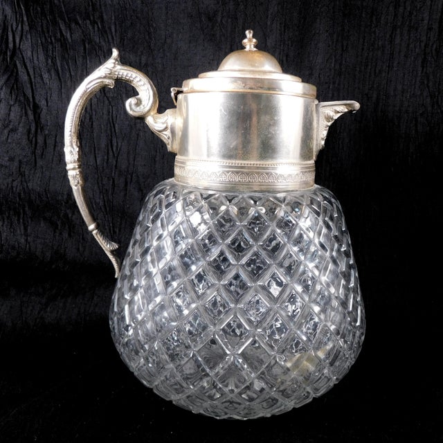 This is a large and heavy cut crystal Edward Latham carafe, jug, bottle, decanter, pitcher, what have you with a silver...