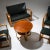 Seating ensemble comprising two armchairs, a two-seater sofa, a stool, and a side table. The pieces are upholstered in...